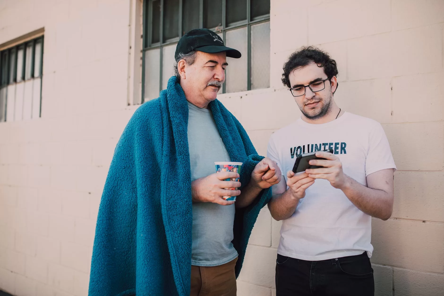 men looking at a smartphone